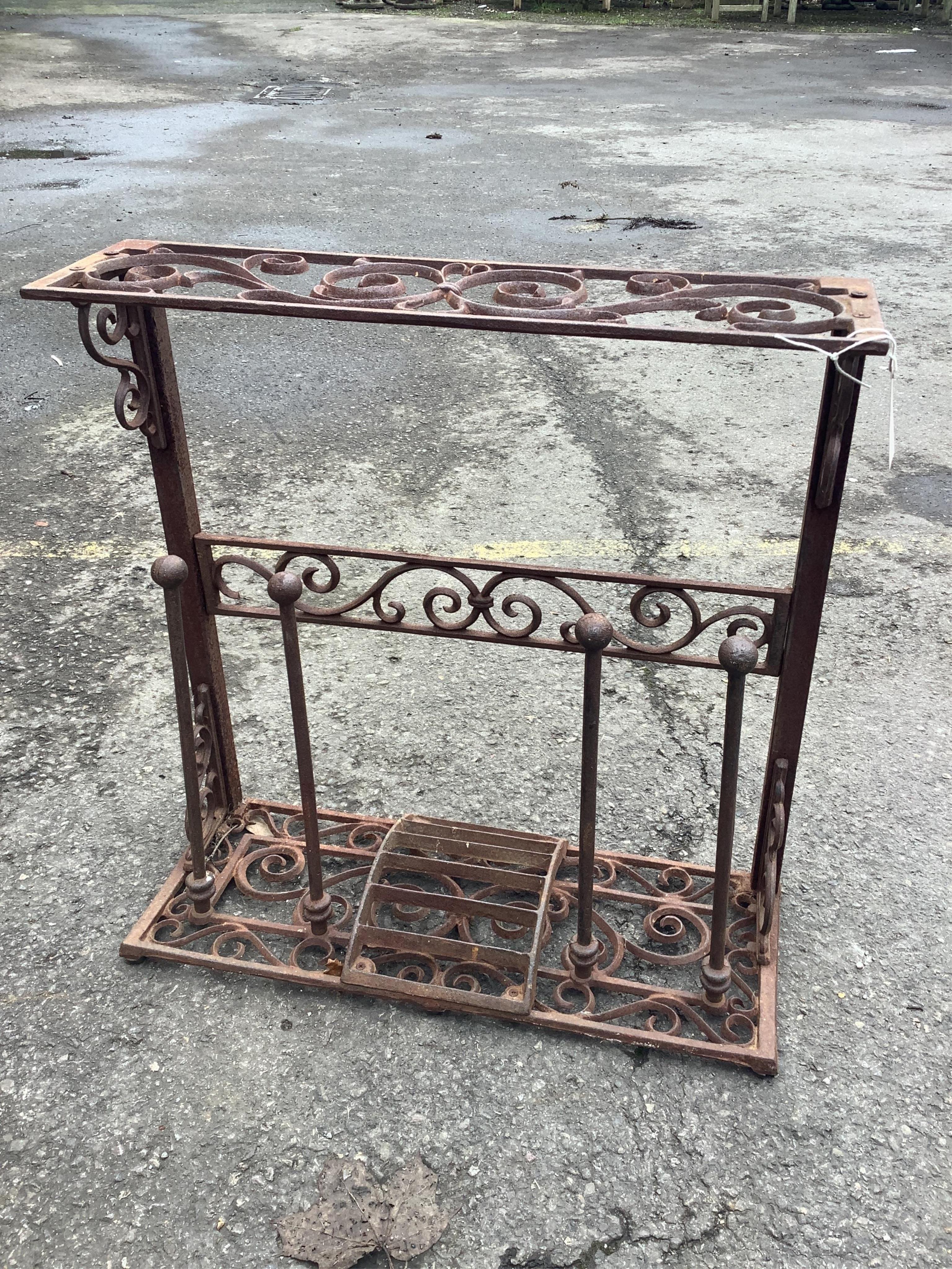 A cast metal boot stand, width 58cm, height 60cm. Condition - fair